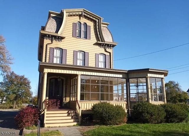 152 Main St, Flemington Boro, NJ 08822 - victorian home featuring mansard roof, a sunroom, and covered porch