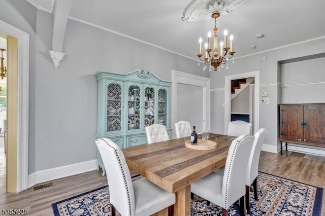 152 Main St, Flemington Boro, NJ 08822 - dining space with a chandelier, wood finished floors, baseboards, stairway, and ornamental molding