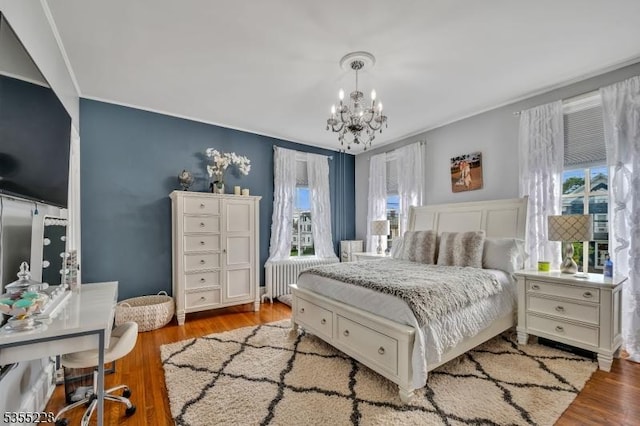 152 Main St, Flemington Boro, NJ 08822 - bedroom featuring a chandelier, radiator, wood finished floors, and crown molding