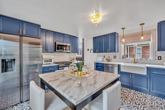 152 Main St, Flemington Boro, NJ 08822 - kitchen featuring appliances with stainless steel finishes, blue cabinetry, a sink, and tasteful backsplash