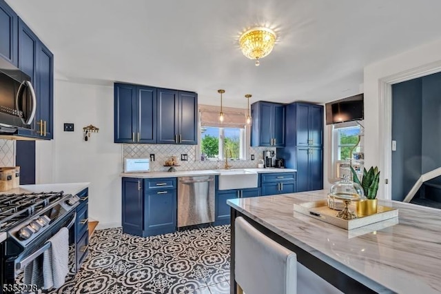 152 Main St, Flemington Boro, NJ 08822 - kitchen with appliances with stainless steel finishes, blue cabinets, a sink, and decorative backsplash
