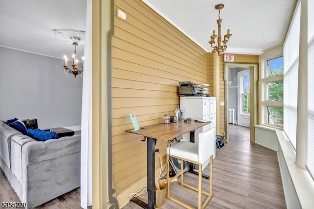152 Main St, Flemington Boro, NJ 08822 - dining room featuring a chandelier, crown molding, wood walls, wood finished floors, and radiator