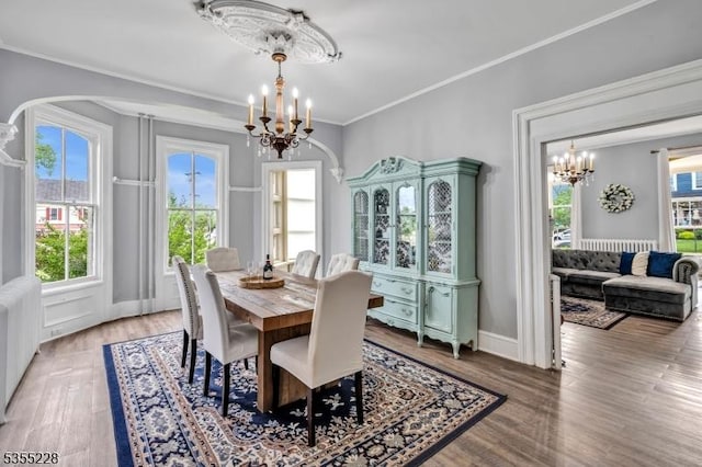152 Main St, Flemington Boro, NJ 08822 - dining space featuring a chandelier, arched walkways, plenty of natural light, wood finished floors, and ornamental molding