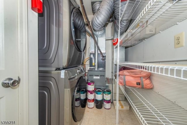 clothes washing area featuring estacked washer and dryer