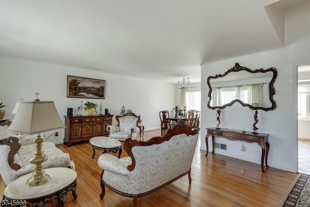 living room featuring light wood-style floors and visible vents