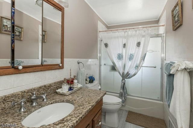 bathroom featuring toilet, enclosed tub / shower combo, ornamental molding, and vanity