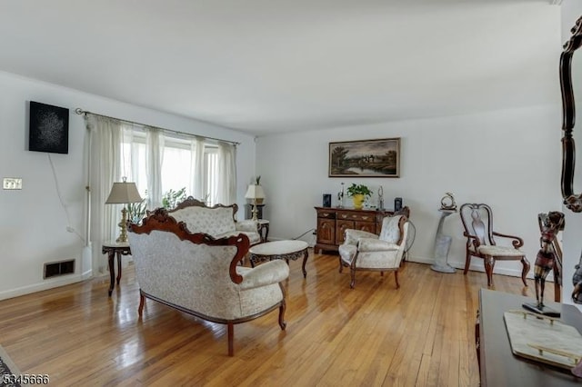 living room with visible vents and light wood-style floors
