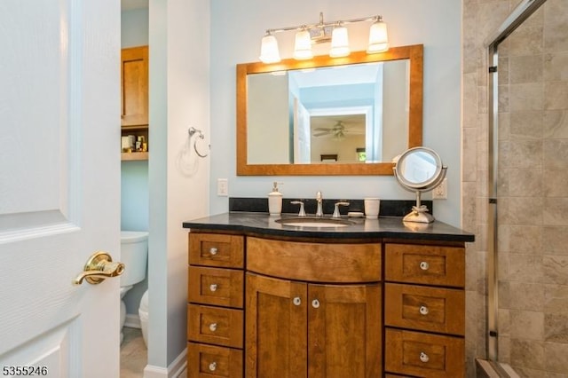 full bathroom featuring vanity, a stall shower, and toilet