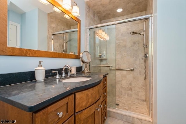 bathroom featuring vanity, tile patterned flooring, and a shower stall