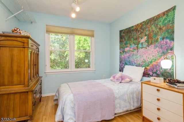 bedroom featuring baseboards and light wood-style floors