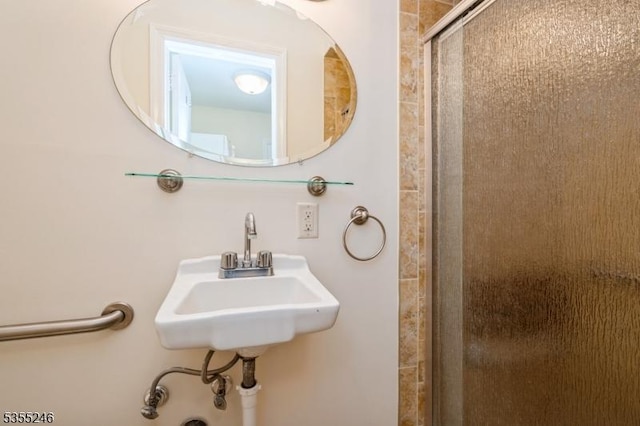 full bathroom featuring a sink and a stall shower
