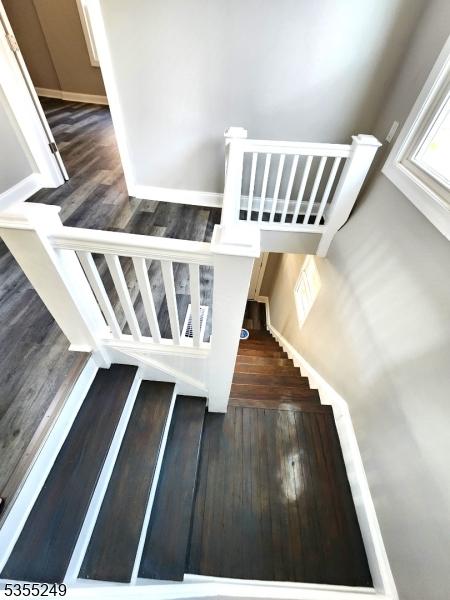 stairway with wood finished floors