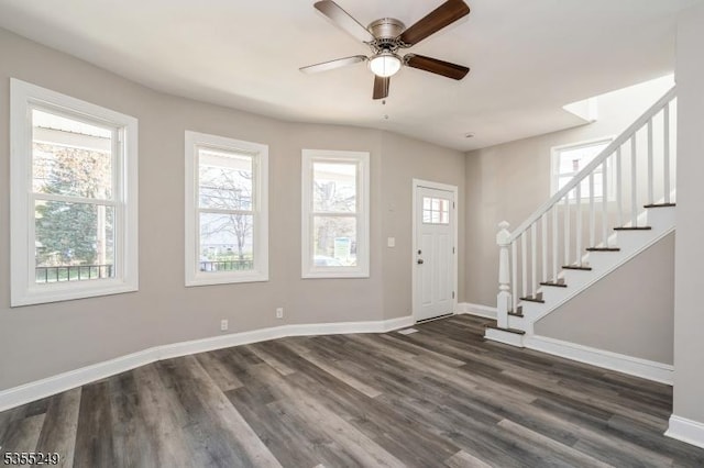 foyer featuring baseboards, dark wood-style floors, and a wealth of natural light