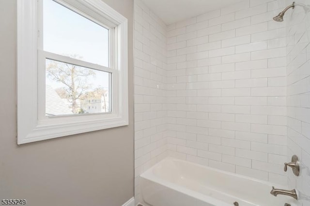 bathroom with tub / shower combination and a wealth of natural light