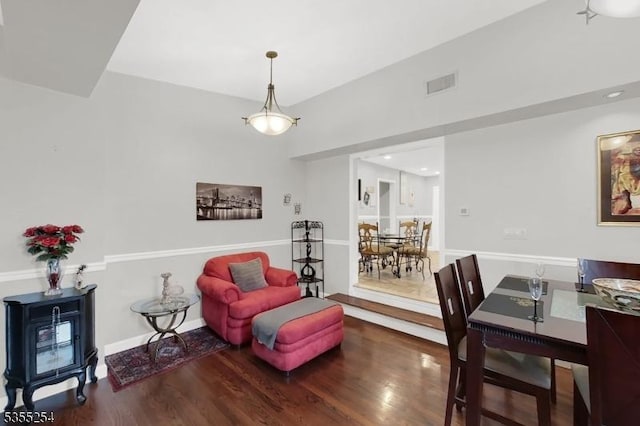 living area featuring wood finished floors, a wood stove, and recessed lighting