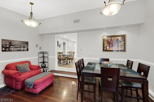 dining space with wood finished floors