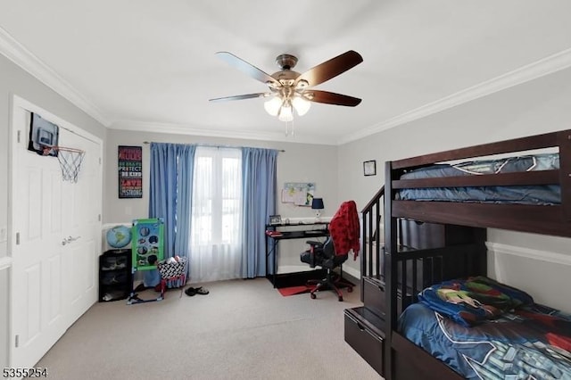 carpeted bedroom with crown molding and ceiling fan