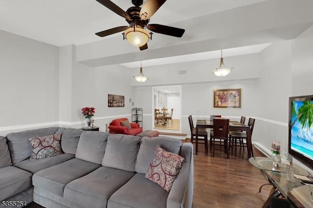 living room with ceiling fan and wood finished floors