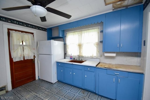 5634 Berkshire Valley Rd, Jefferson Twp, NJ 07438 - kitchen featuring a sink, freestanding refrigerator, crown molding, light countertops, and blue cabinets