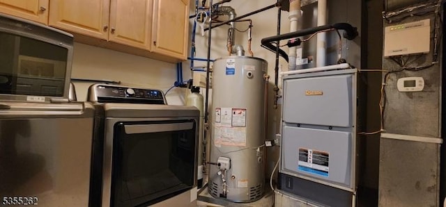 utilities with water heater and washer and clothes dryer