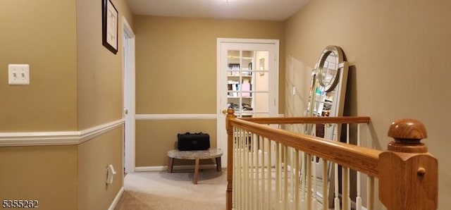 hall with carpet floors and baseboards
