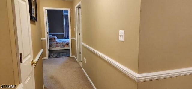 hall with carpet floors and baseboards