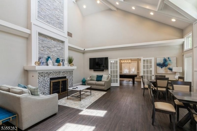 living area featuring recessed lighting, a fireplace, wood finished floors, and high vaulted ceiling