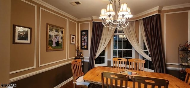 dining room with an inviting chandelier, ornamental molding, visible vents, and a decorative wall