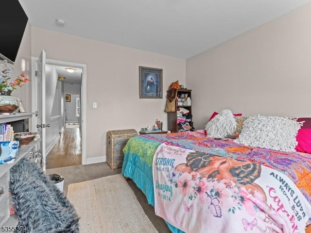 bedroom featuring carpet floors and baseboards