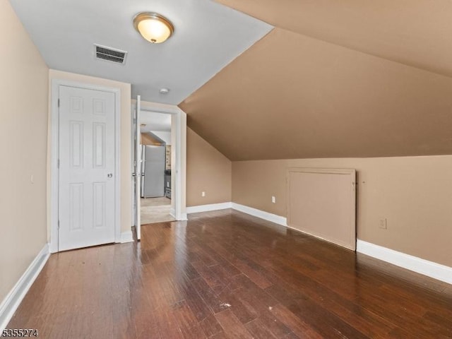 additional living space with visible vents, baseboards, and wood finished floors