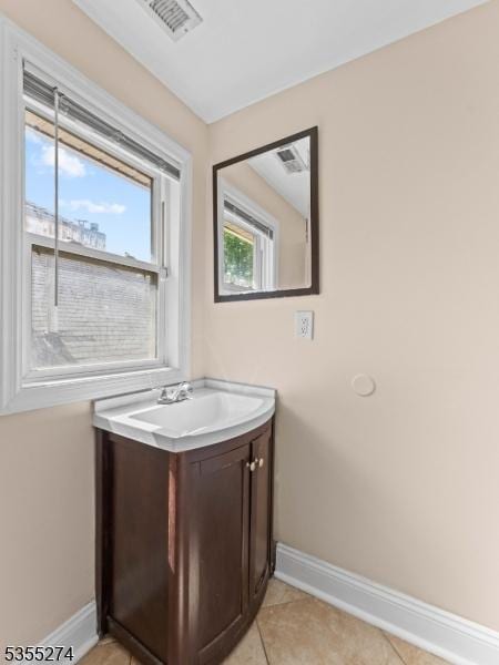 bathroom with baseboards, visible vents, tile patterned floors, and vanity