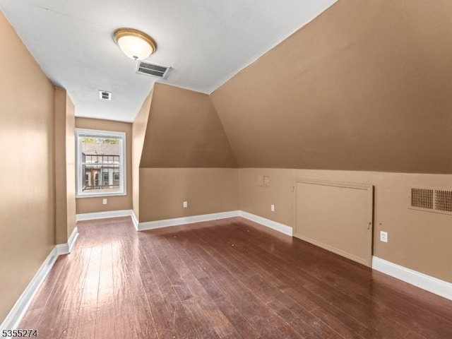 additional living space featuring visible vents and hardwood / wood-style flooring