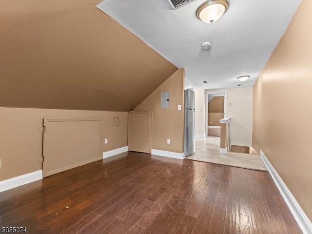 bonus room featuring baseboards and hardwood / wood-style flooring