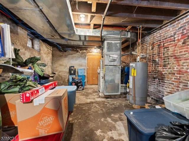 unfinished below grade area featuring brick wall, heating unit, and water heater