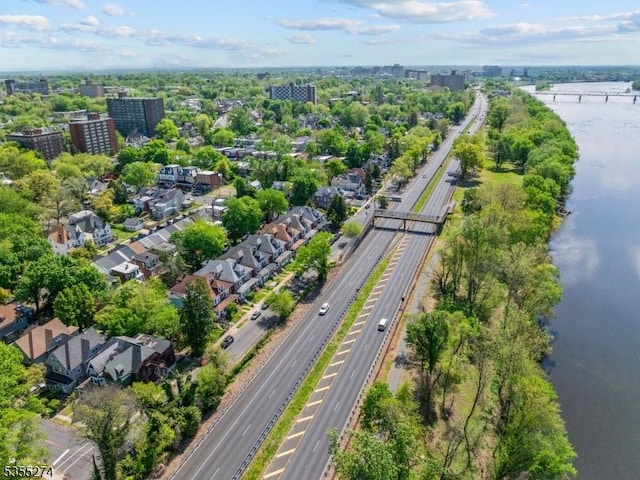 birds eye view of property with a view of city and a water view