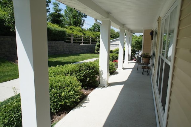 view of patio / terrace featuring fence and covered porch