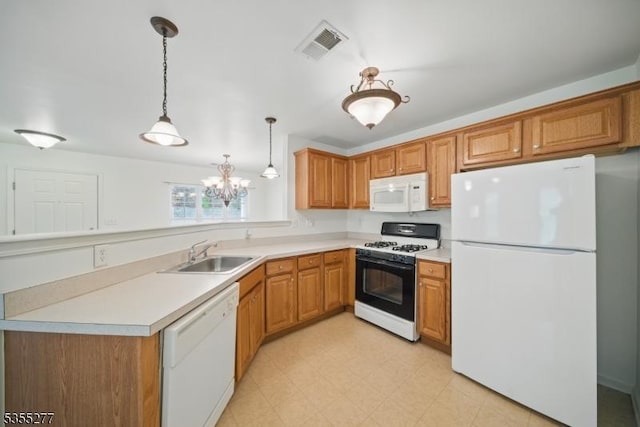kitchen with an inviting chandelier, a sink, white appliances, a peninsula, and visible vents