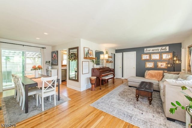living room with light wood-type flooring and baseboards