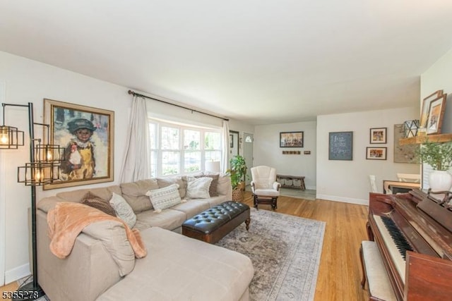 living area with light wood-style floors and baseboards
