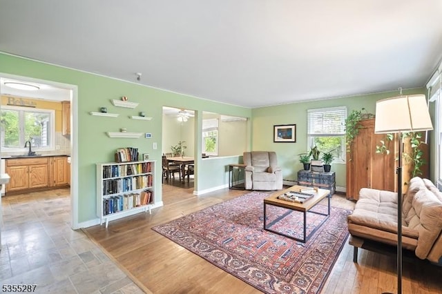 living area with plenty of natural light, baseboards, and a baseboard radiator