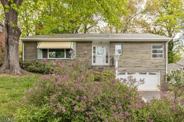 single story home featuring stone siding and a garage