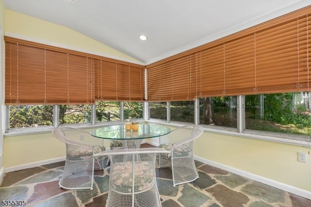 sunroom featuring recessed lighting, baseboards, stone finish flooring, and lofted ceiling
