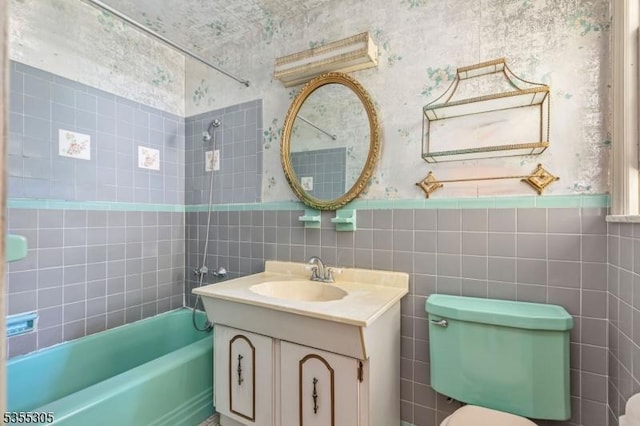 full bathroom with tile walls and wallpapered walls