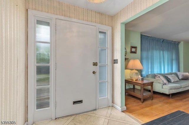 doorway with wallpapered walls and a wealth of natural light