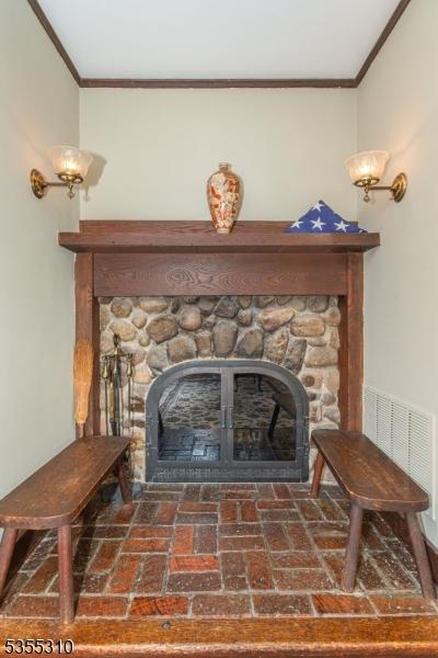 detailed view of a fireplace and crown molding