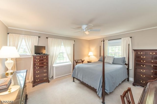 carpeted bedroom with radiator, multiple windows, crown molding, and a ceiling fan
