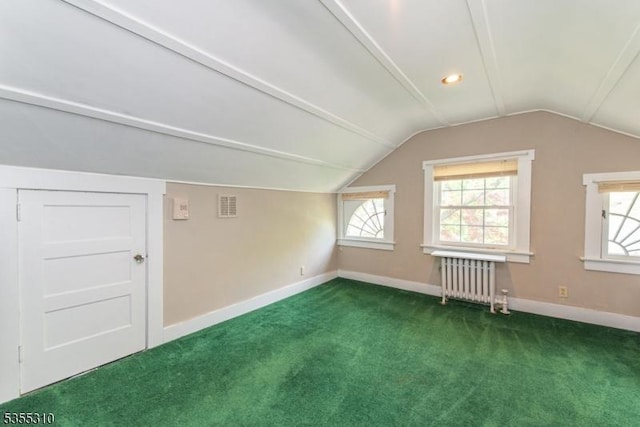 bonus room with radiator heating unit, vaulted ceiling, carpet, and baseboards