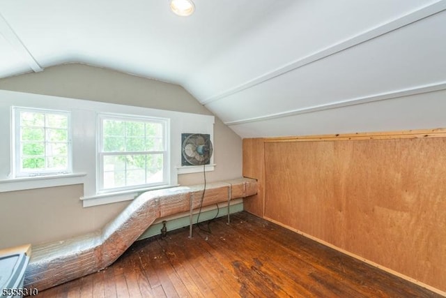 additional living space with dark wood finished floors and vaulted ceiling