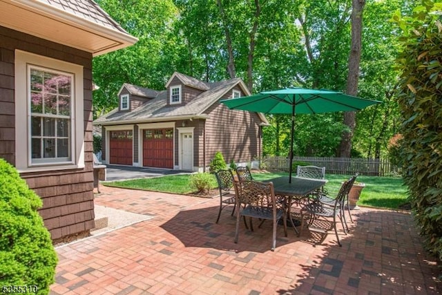 view of patio / terrace featuring an outbuilding and outdoor dining area