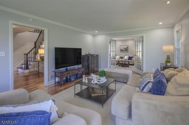 living room featuring recessed lighting, ornamental molding, stairs, and wood finished floors